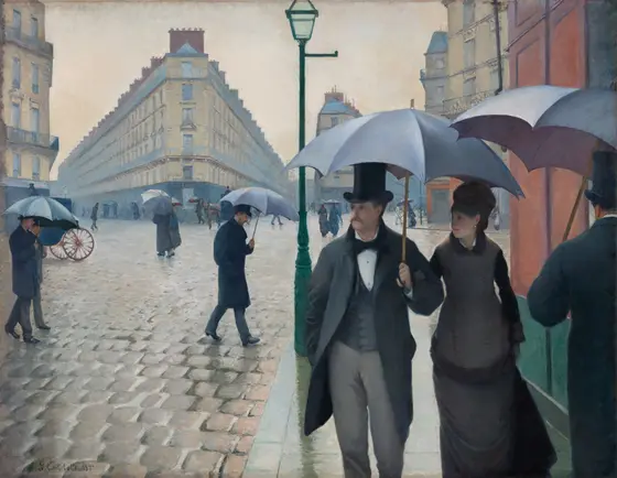 Life-size painting of an urban scene in Paris. A man in a top hat holding an umbrella and a woman in a long fashionable dark dress walk arm in arm toward the viewer as other city dwellers with umbrellas walk in various directions across cobblestone roads and sidewalks.