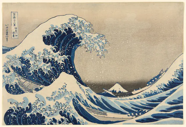 A towering blue-and-white wave with claw-like curls of foam arches over three long, narrow boats of crouching rowers, while snow-capped Mount Fuji sits small and low in the distance under a pale sky.