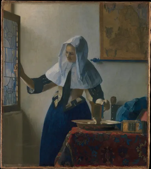 A young woman in a white linen hood and collar, yellow bodice and blue skirt stands at a leaded-glass window, one hand opening the casement and the other resting on a gilt silver pitcher in a matching basin on a table covered with a red patterned carpet; a map hangs on the pale wall behind her.