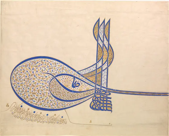 The sultan’s calligraphic monogram in blue ink and gold on cream paper: three tall vertical strokes rise from a base of interlaced letters, with a large oval loop to the left and long strokes sweeping off to the right, all filled with fine blue and gold floral scrolls.
